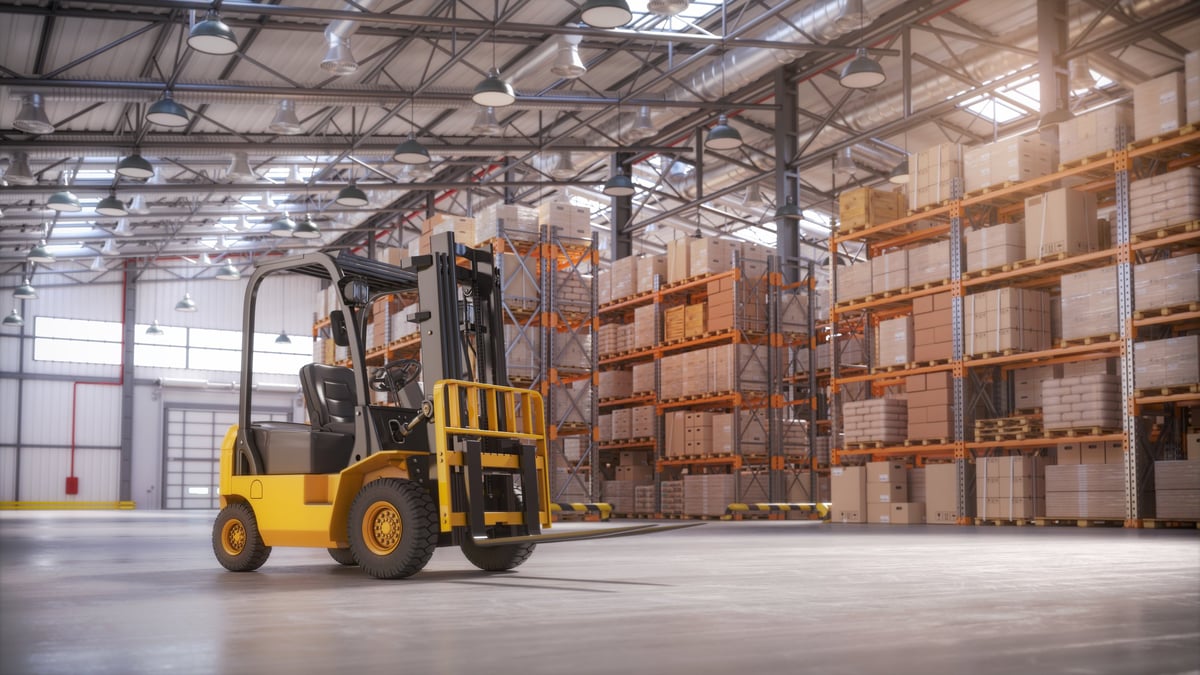 Retail warehouse filled with tall racks of cardboard boxes and packages, illustrating warehouse management system software, storage operations and order fulfilment