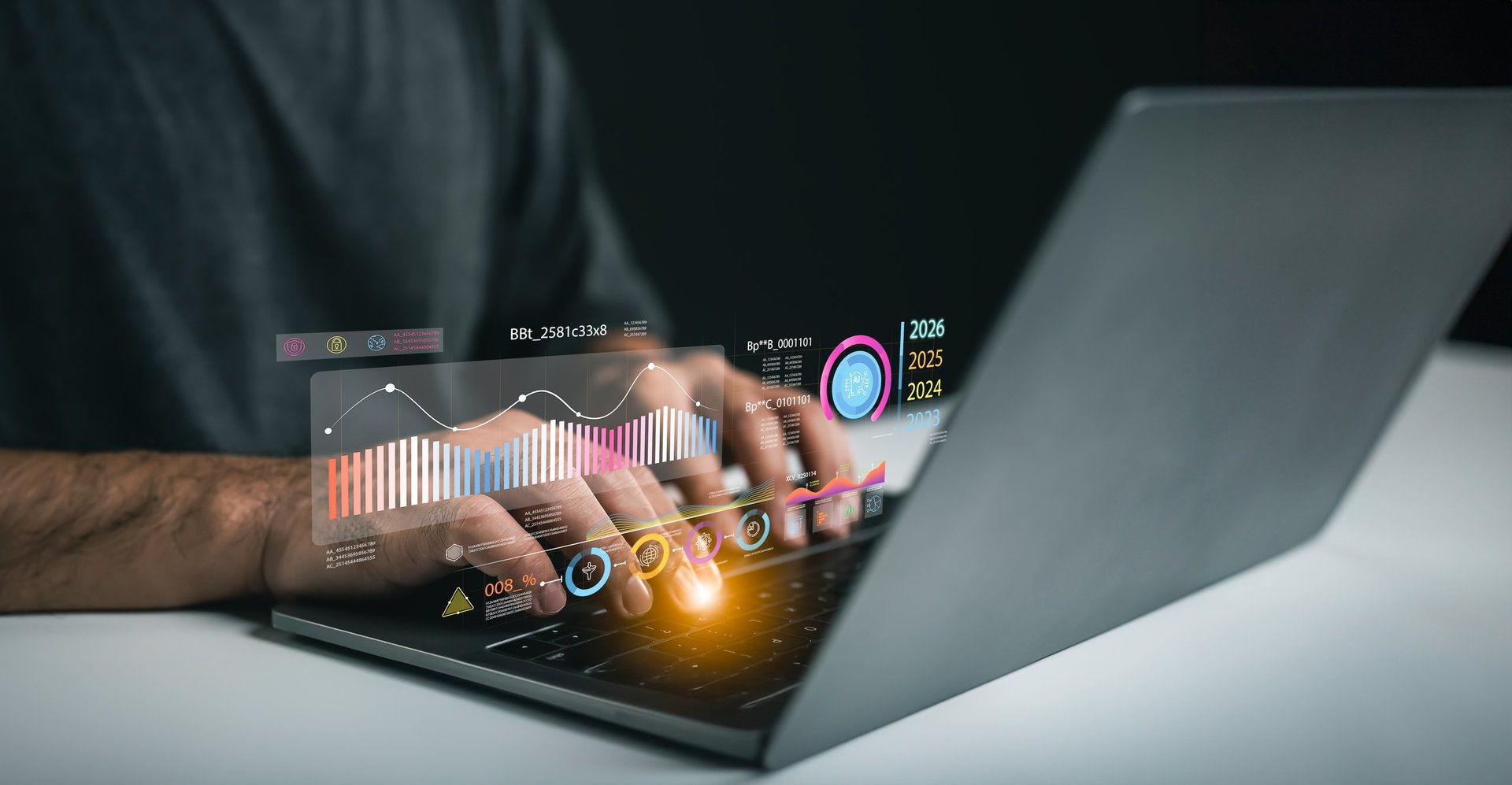 Close-up of a person using a laptop to analyze data with digital graphs and charts, showcasing innovation and technology in a modern workspace for business insights.