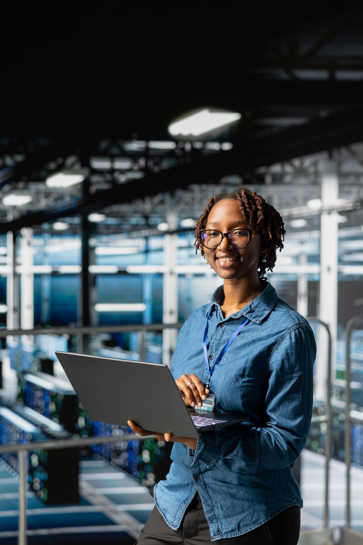 Young African woman engineer focused on technical work using a laptop