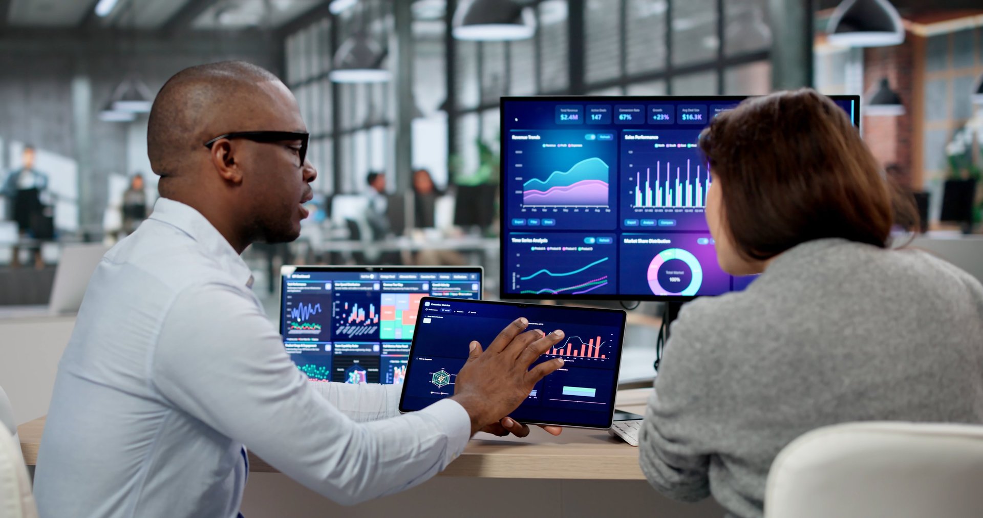 Analyst examining KPI dashboards across multiple screens, representing real-time skills analytics