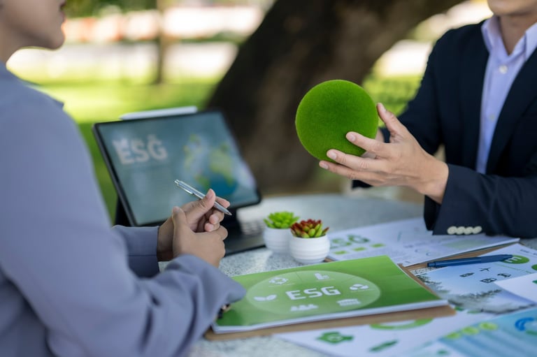 Two business professionals discussing esg strategy and environmental impact outdoors