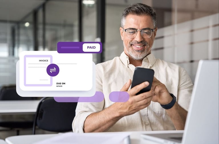 Man holding smartphone in office with invoice payment interface overlay showing paid status